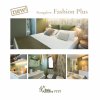 Camera da letto moderna con letto matrimoniale, decori eleganti e tonalità verde.