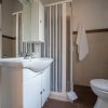 Un bagno con doccia, lavandino e WC.