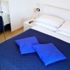 Letto con copriletto blu e cuscini azzurri.