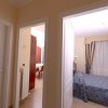 Due porte aperte su camere, una da letto e una sala.