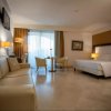 Camera d'hotel con letto, divano e tavolo.