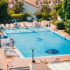 Piscina esterna con lettini e ombrelloni.
