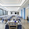 Sala ristorante con tavoli coperti di tovaglie blu.